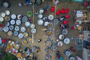 Rural Life Prints: An aerial view captures an extensive cooking setup for a wedding ceremony at a rural home in the Haor region of