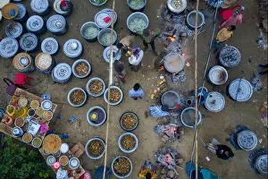 Rural Life Prints: An aerial view captures an extensive cooking setup for a wedding ceremony at a rural home in the Haor region of