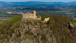 Medieval Architecture Prints: An aerial view captures the medieval Chojnik Castle atop a mountain in the Karkonosze range