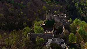 Medieval Architecture Prints: An aerial view captures the medieval Chojnik Castle atop a mountain in the Karkonosze range