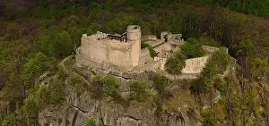 Medieval Architecture Prints: An aerial view captures the medieval Chojnik Castle atop a mountain in the Karkonosze range