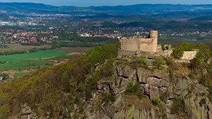 An aerial view captures the medieval Chojnik Castle atop a mountain in the Karkonosze range