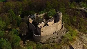 An aerial view captures the medieval Chojnik Castle atop a mountain in the Karkonosze range