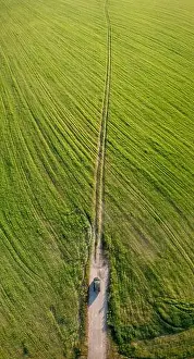 Aerial view of car SUV parked near countryside road in field rural landscape. Aerial view of car SUV parked near countryside road in summer field