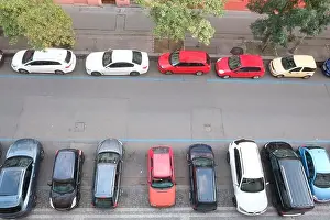 Parking Area Prints: Aerial view of cars parallel parked and perpendicular parked on either side of Prague street