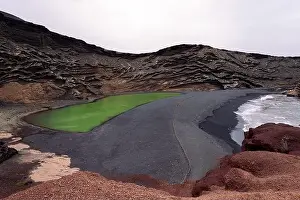 Foamy Prints: Aerial view of Charco Verde against foamy ocean on highland in Golfo Yaiza Lanzarote Canary Islands Spain