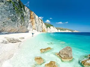 Mid Adults Prints: Aerial view of cheerful man with arms outstretched admiring the crystal sea at Fteri Beach