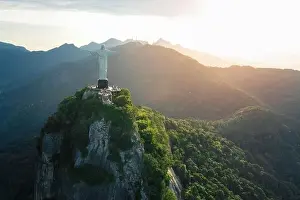 Aerial view of Christ the Redeemer Statue on top of Corcovado Mountain at sunset - Rio de Janeiro, Brazil