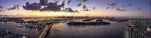 Miami Beach Prints: Aerial view of the city skyline casting a warm glow on the water