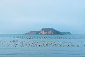 Fujian Prints: Aerial view of the cliff and mountain coastline at sunrise in Dongshan Island