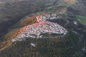 Basilicata Prints: Aerial view of the clustered rooftops of Rotondella cascade down the hillside