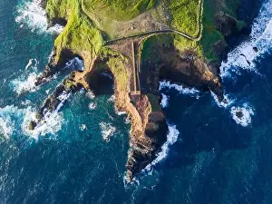 Lighthouses Prints: Aerial view of the coasts and cliffs of the island of Sao Miguel over the lighthouse of Farolim dos Fenais da Ajuda