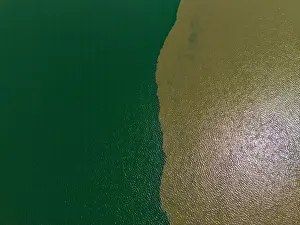 Harmony Prints: Aerial view of the confluence of the Mekong and Tonle Sap rivers surrounded by serene and tranquil landscapes