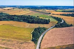 Images Dated 1st September 2019: Aerial view of a country road amid fields against blue clear sky