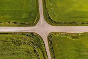 Crossroads Prints: aerial view of a crossroads on country gravel no traffic road among fields