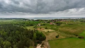 Masuria Prints: Aerial view of dark moody sky above Nowe Guty village and Sniardwy lake