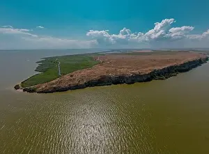 Sea Cliffs Prints: Aerial view of Dolosman Cape with Argamum fortress located in Tulcea county
