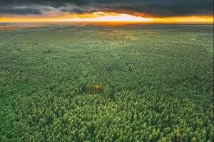 Aerial Landscape Collection: Aerial View Of Dramatic Sky Above Green Forest Landscape In Evening