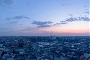 Reddish Prints: Aerial view from drone. Aerial view amazing sunset over of the suburbs with the city