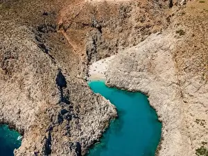Aerial top view by drone of beach of Seitan Limania in bay with turquoise water and an unusual shape in Akrotiri, Crete
