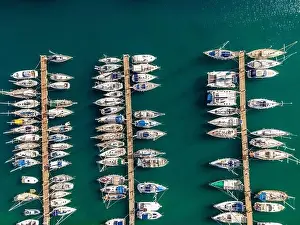 Aerial top view by drone of boats and yachts in mediterranean harbor. View in summer sunny day