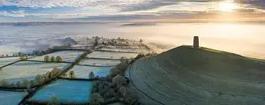 Aerial view by drone of frosty winter morning at Glastonbury Tor, Somerset, England, United Kingdom, Europe