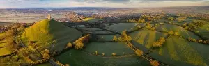 Typically Prints: Aerial view by drone of Glastonbury Tor on a frosty morning on the Somerset Levels