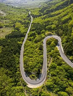 Forest Road Prints: Aerial view of drone to road through mountain with bends