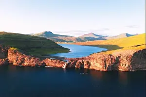 Aerial view from drone of Sorvagsvatn lake on cliffs of Vagar island in sunset time, Faroe Islands, Denmark. Landscape photography