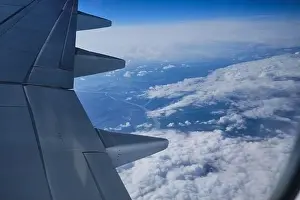 Aerial view of the Earth landscape. Map view with clouds and river from airplane porthole