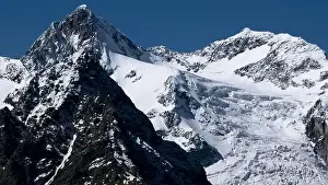 Quadcopter Prints: Aerial view of epic winter snow covered mountains on a blue background