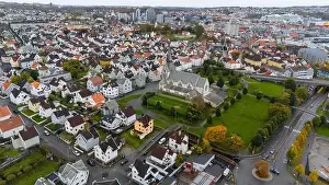 Industrial Area Prints: Aerial view of a European city with a prominent church surrounded by residential houses and greenery