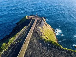 Aerial view of Farolim dos Fenais da Ajuda lighthouse on a cliff