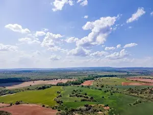 Cropland Prints: Aerial view of fields of Castile with agricultural plots and blue sky with clouds