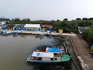 Aerial view of fisherman village and mangrove forest in rainy season. Bekasi, Indonesia, March 9, 2021