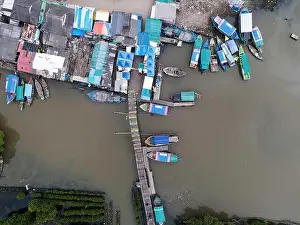 Aerial view of fisherman village and mangrove forest in rainy season. Bekasi, Indonesia, March 9, 2021