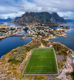 Lofoten Islands Prints: Aerial view of football field or soccer field in the Henningsvaer with mountains in the background