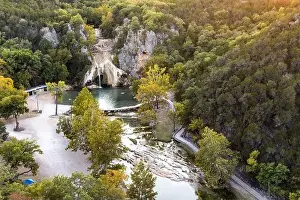 Downpour Prints: Aerial view of forest on hills and natural pool at Turner Falls in Oklahoma