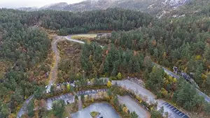 Winding Road Prints: Aerial view of a forested area with winding roads and parking lots