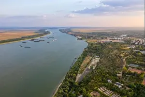 Aerial view of Galati City, Romania. Danube River near city with sunset warm light