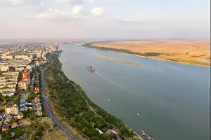 Aerial view of Galati City, Romania. Danube River near city with sunset warm light