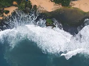 Yogyakarta Prints: Top down aerial view of giant ocean waves crashing and foaming in coral beach