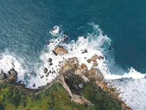 Yogyakarta Prints: Top down aerial view of giant ocean waves crashing and foaming in coral beach