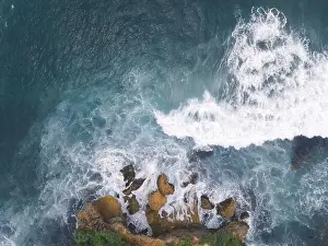 Yogyakarta Prints: Top down aerial view of giant ocean waves crashing and foaming in coral beach