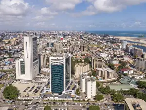 Nigeria Prints: Aerial view of gleaming skyscrapers and bustling streets meet the azure waters of the Lagos Lagoon