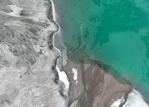 Polluted Prints: Aerial view of green or turquoise polluted water with dirt flowing into a lake from a thermal plant or chemical