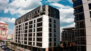 Aerial view of a high residential building of a newly built city aeria. Stock footage. Concept of urbanization