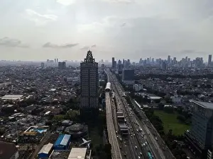 Interchange Prints: Aerial view of highway intersection and buildings in the city of Jakarta and noise cloud with Jakarta cityscape