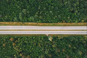 Aerial View Of Highway Road Through Green Forest Landscape In Summer. Top View Flat View Of Highway Motorway Freeway From High Attitude. Trip And Trav