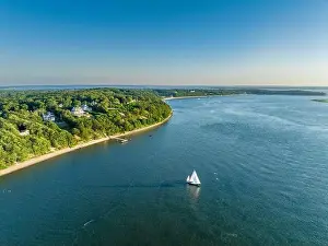 White Sails Prints: aerial view of homes on Shelter Heights water front homes and a sailboat